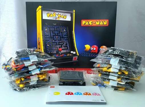 Image of the contents of the boxed set displaying bags of Lego pieces and instruction manual of the Lego Pac Man Set 10323