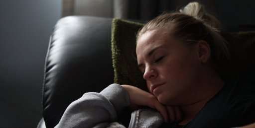 Image of a woman comfortably sleeping in and office chair