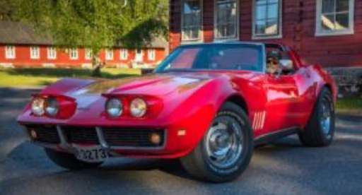 Classic red sports car parked in front of a rustic building, representing the rewards of financial planning and part-time work for a retired person looking for part-time work.