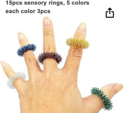 Image of 15 Pack Spiky Sensory Finger Acupressure Massage Rings Fidget Toys by FRIMOONY. Image showing a hand wearing 5 different coloured rings. Image links to amazon marketplace for more details and purchase option.