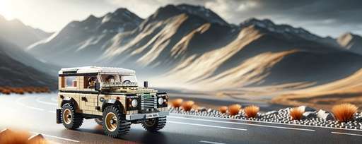 Close-up of the LEGO Icons Land Rover Classic Defender 90 model on a rugged mountain road, highlighting the intricate design and unique color scheme of the LEGO set against a blurred mountainous backdrop