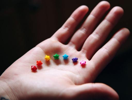 A hand holding rainbow coloured tiny stars, Lego’s journey towards gender inclusivity